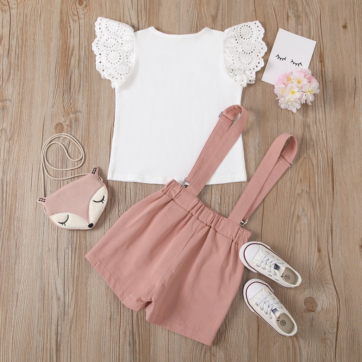 Eyelet top and dungaree shorts set