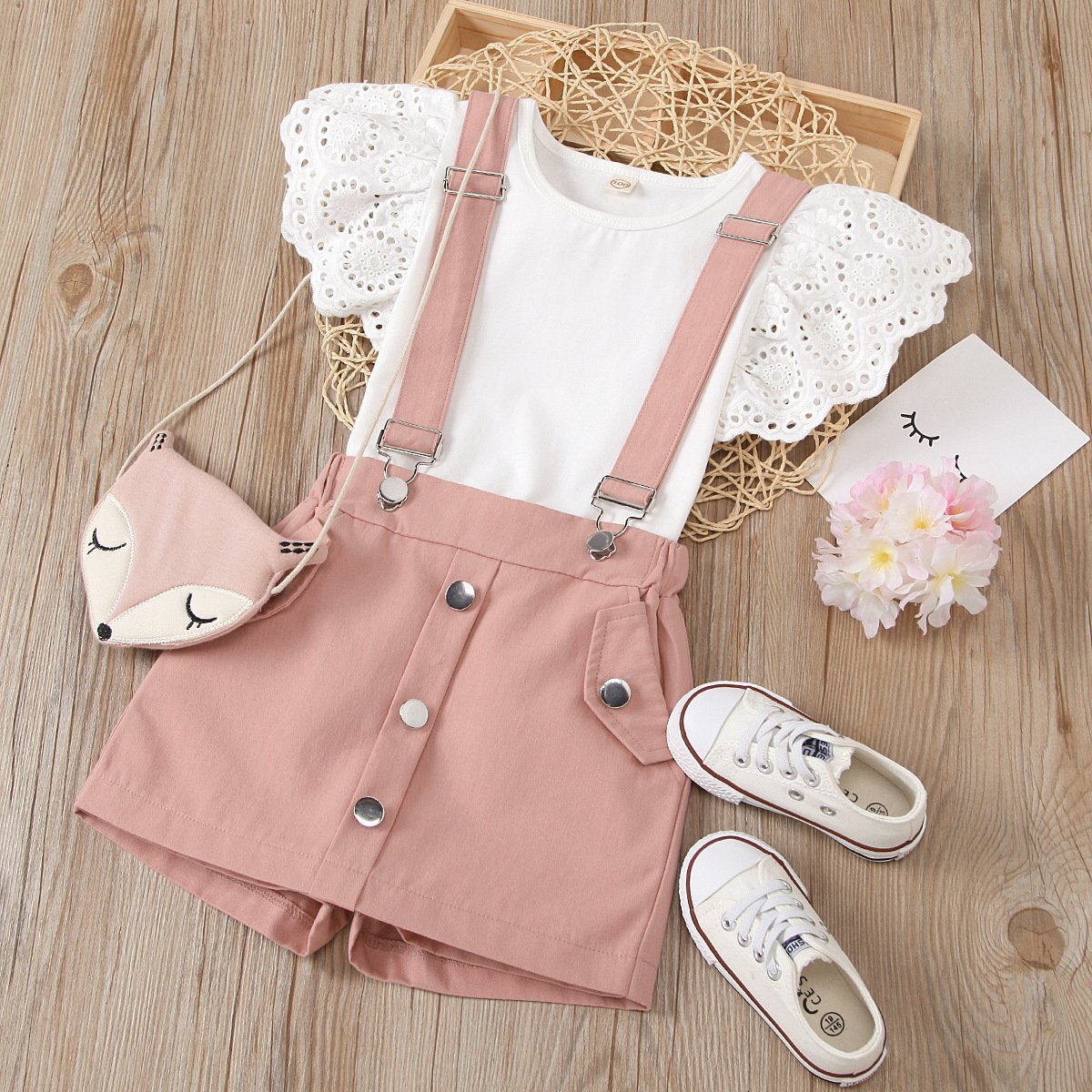 Eyelet top and dungaree shorts set